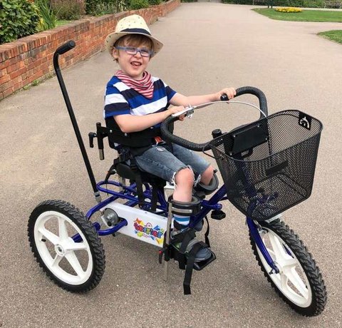 A child riding his very cool Whizz Kidz trike