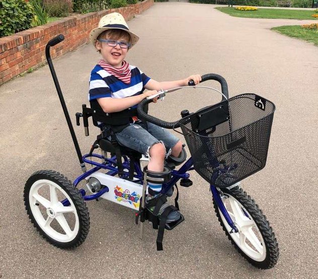 A child riding his very cool Whizz Kidz trike