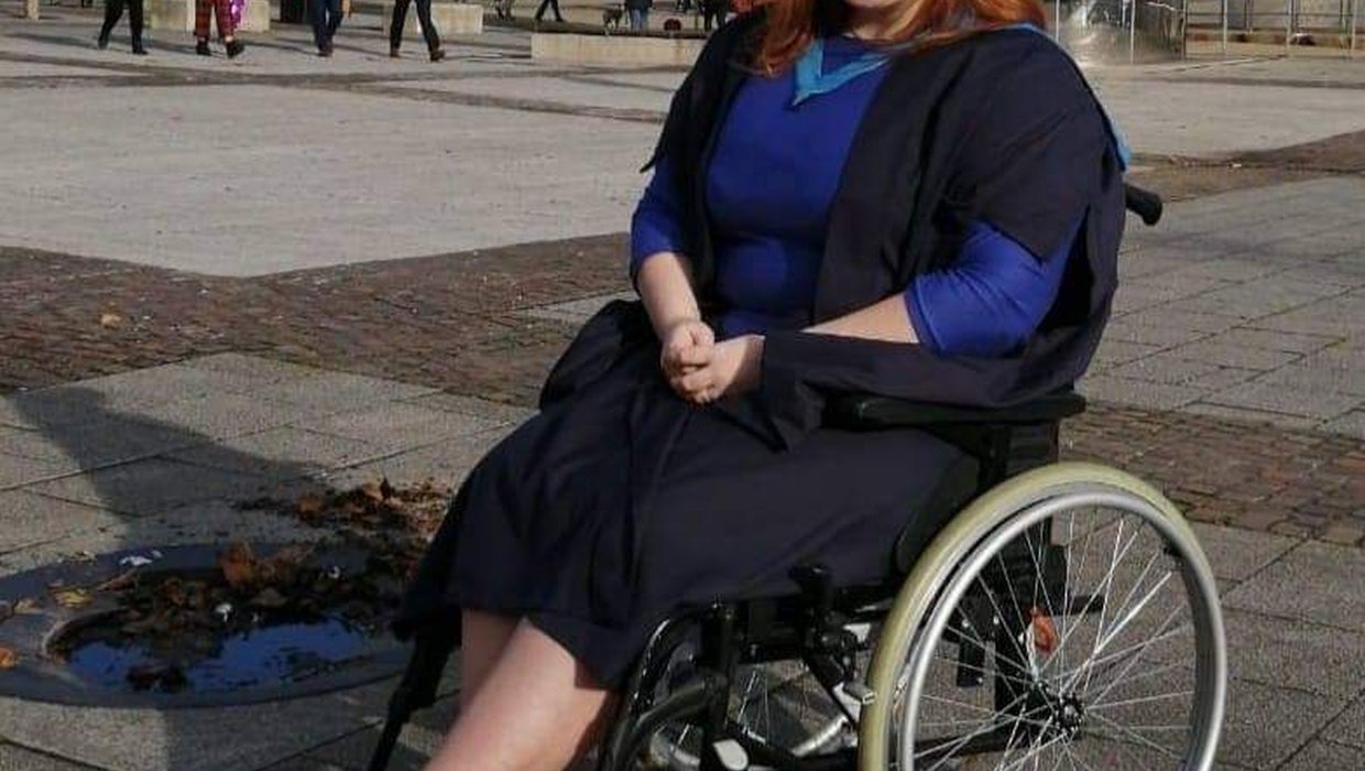 Sophie in her manual wheelchair on her graduation day