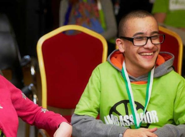 Two young people, sitting and smiling