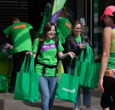 The Whizz Kidz team handing out bags to our amazing runners