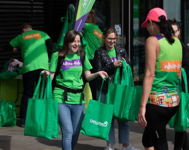 The Whizz Kidz team handing out bags to our amazing runners