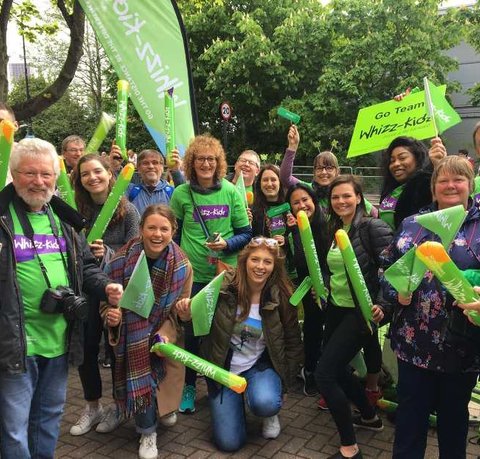 The Whizz Kidz team posing for a picture at a cheer point