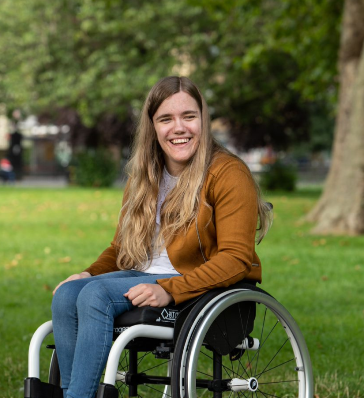 Smiling girl in Whizz Kidz wheelchair